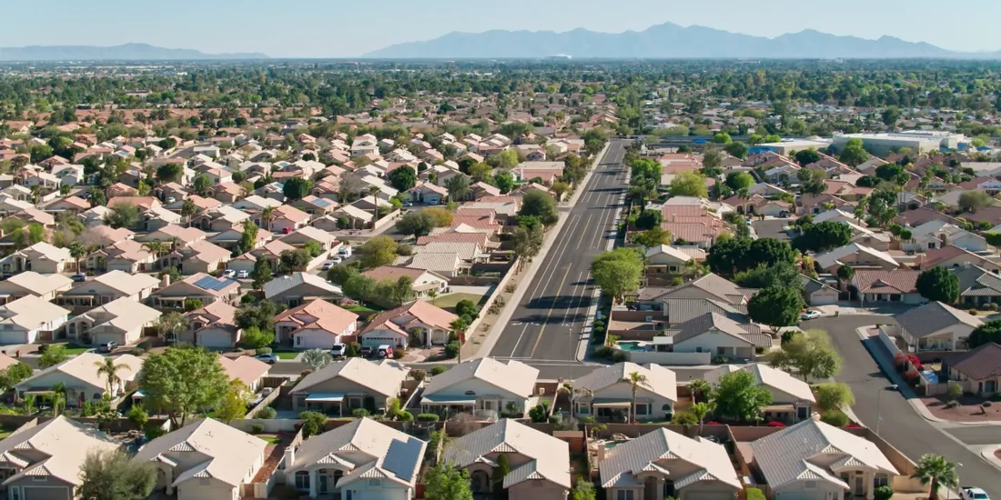 Aerial view of a Mesa neighborhood with mountains beyond